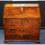 A George III style oak writing bureau, with a hinged writing flap,