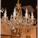 A crystal chandelier, with eight scroll branches,