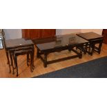 An oak coffee table, with glass protector top, together with a matching nest of three oak tables,