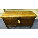 An oak coffer circa late 17th century, with hinged top decorated with carved lozenges to the front,