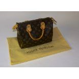 A Louis Vuitton Speedy 25 handbag, in traditional monogram leather design,