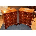 A pair of reproduction chests of drawers, each with two small drawers above three long drawers,