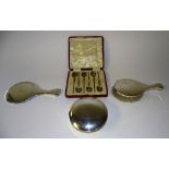 A boxed set of six silver teaspoons, hallmarks for London 1910, with intricate foliate decoration,