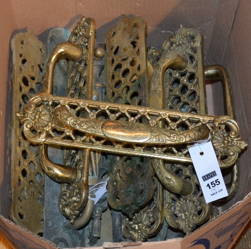 A collection of period brass door handles and door plates,