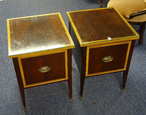 A pair of reproduction bedside cupboards, bearing label for William L Maclean, with pull out drawer,