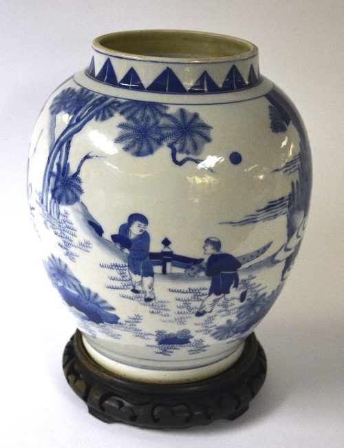 A Chinese blue and white ovoid vase, on hardwood stand,