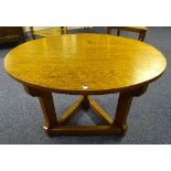 A heavy oak occasional table, raised on triangular beam base,