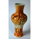 A Chinese ovoid vase, decorated allover with Chinese symbols on mottled orange ground,