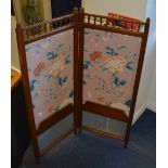 A late Victorian mahogany folding screen, decorated with floral panels,