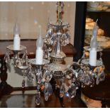 A crystal and silver plated chandelier, with five scroll branches,