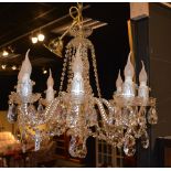 A crystal chandelier, with eight scroll branches,