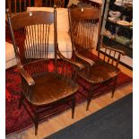 A pair of vintage Elm farmhouse style armchairs, with spindle supports above solid seats,