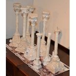 A collection of eight marble and composite columns,