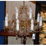 A crystal chandelier, with multiple scroll branches,