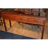 A Chinese hardwood serving table, the three short drawers to top, with carved foliate handles,