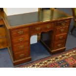 A Victorian kneehole desk, with green tooled inset to the top, above central drawer,