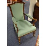 A Victorian mahogany framed open armchair, upholstered in later pale green fabric,