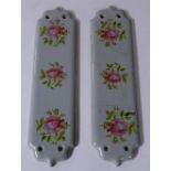 A pair of pottery door finger plates, decorated with panels of roses, 30cm high x 8.