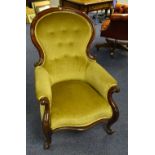 A Victorian mahogany framed armchair, upholstered in later gold buttonback velour,