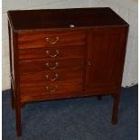 A mahogany music cabinet, with five drawers opposite a panelled door,