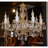 A crystal chandelier, with eight scroll branches,