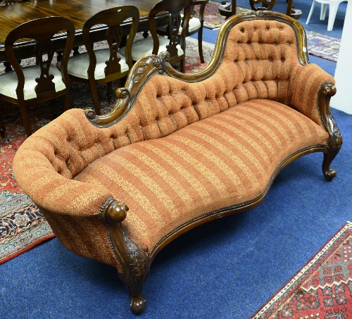 A Victorian style mahogany chaise style settee, upholstered in striped rust velour,