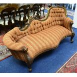 A Victorian style mahogany chaise style settee, upholstered in striped rust velour,