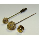 A 15ct gold and diamond dress stud, together with similar yellow metal and diamond tie pin,