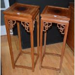 A pair of Chinese hardwood jardiniere stands, the square panelled top above Chinese design frieze,