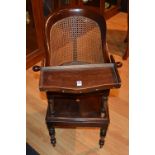 A Victorian mahogany child's high chair, with caned back and seat with swivel food tray,