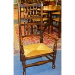 A Scottish style oak ladder back chair, with low rush seat,