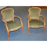A pair of French elbow chairs, upholstered in green velour,