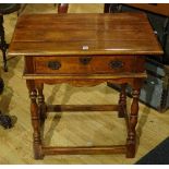 A reproduction oak console table by Theodore Alexander,