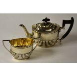 A silver teapot and similar sugar bowl, hallmarks for Birmingham with date rubbed,