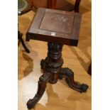 A Victorian mahogany carved table base, raised on tripod supports,