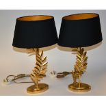 A pair of modern gilt painted table lamps with shades,