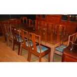 A Chinese hardwood dining table and 10 chairs, the four section panelled top with glass protector,