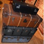 Three vintage travel trunks, two of wood bound design and one of metal casing,