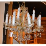 A crystal chandelier, with eight scroll branches,