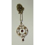 A 9ct gold ruby and seed pearl pendant, with two round cut ruby drops to centre and base,