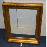 A period giltwood picture frame, with ornate fluted and foliate decoration,