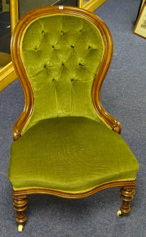 A Victorian lady's walnut armchair, upholstered in green buttonback velour,