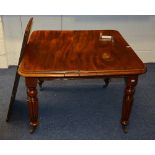A mahogany extending dining table, with additional leaf,