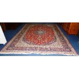 A Persian carpet, with central floral motif surrounded by floral swags,