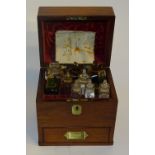 A 19th century mahogany chemist box, with hinged top enclosing 10 assorted glass bottles,