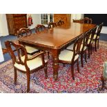 A Victorian style mahogany dining table with 10 Victorian style dining chairs,