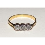 A gold three stone diamond ring, the three brilliant cut diamonds within illusion setting, approx.