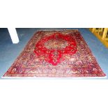 A Tabriz carpet, the large geometric and floral motif on red ground,