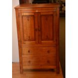 A vintage oak cupboard chest, with two Art Nouveau style panelled doors above two drawers,