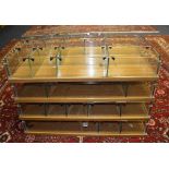 A set of four shop haberdashery racks, each with open glass sections, raised on oak backing,